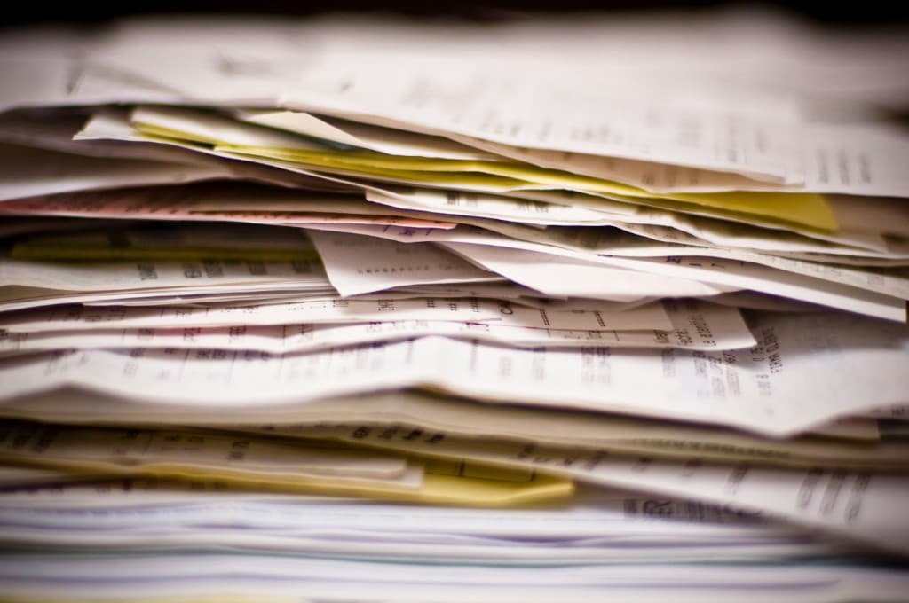 Close-up of a thick stack of printed documents and receipts
